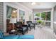 Comfortable screened-in porch featuring stylish wicker furniture with blue striped cushions at 227 Chimney Rise Dr, Cary, NC 27511