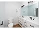 Clean, modern bathroom featuring double sinks, white cabinets, and sleek black hardware at 2517 Newbold St, Raleigh, NC 27603