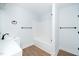 This all-white bathroom features a modern sink and a shower-tub combo at 2517 Newbold St, Raleigh, NC 27603