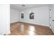 This bedroom has wood floors and white walls with two windows overlooking the neighborhood at 2517 Newbold St, Raleigh, NC 27603