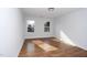 This bedroom has wood floors and two windows overlooking the neighborhood at 2517 Newbold St, Raleigh, NC 27603