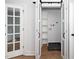 Laundry room with white shelving seen through modern sliding doors at 2517 Newbold St, Raleigh, NC 27603