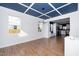 Open-concept living room featuring a unique coffered ceiling and modern light fixture, seamlessly connected to the kitchen at 2517 Newbold St, Raleigh, NC 27603