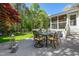 Outdoor dining on the back deck overlooking the lush backyard and manicured landscaping at 255 Williamston Ridge Dr, Youngsville, NC 27596