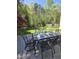 Inviting backyard dining area with ornate metal table set and a manicured lawn, perfect for outdoor entertaining at 255 Williamston Ridge Dr, Youngsville, NC 27596