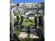 Serene backyard framed by a white pergola, enhancing the beauty of the green lawn and landscaping at 255 Williamston Ridge Dr, Youngsville, NC 27596