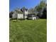 Spacious backyard featuring a well-manicured lawn, screened-in porch, and mature landscaping, attached three-car garage at 255 Williamston Ridge Dr, Youngsville, NC 27596