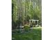 Backyard featuring an elegant pergola, manicured lawn, and lush landscaping at 255 Williamston Ridge Dr, Youngsville, NC 27596