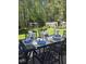 Elegant outdoor dining setup on a backyard patio with a lush green lawn and mature trees at 255 Williamston Ridge Dr, Youngsville, NC 27596