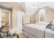Bright bedroom featuring two beds, soft carpet, and a decorative window with arched top at 255 Williamston Ridge Dr, Youngsville, NC 27596