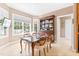 Bright dining room with a classic hutch, a wood table, and a bay window overlooking the backyard at 255 Williamston Ridge Dr, Youngsville, NC 27596