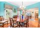 Charming dining room featuring a gorgeous chandelier, hardwood floors, and cheerful natural light at 255 Williamston Ridge Dr, Youngsville, NC 27596