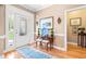 Inviting foyer features hardwood floors, a decorative rug, and a stylish console table with seating at 255 Williamston Ridge Dr, Youngsville, NC 27596
