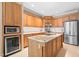 Spacious kitchen with a granite island, stainless steel appliances, and ample wood cabinetry at 255 Williamston Ridge Dr, Youngsville, NC 27596