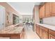 Well-lit kitchen featuring granite countertops, custom cabinets, and a view into the dining area at 255 Williamston Ridge Dr, Youngsville, NC 27596