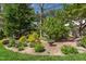 Well-manicured landscaping with mature trees, shrubs, flowers and decorative statuary at 255 Williamston Ridge Dr, Youngsville, NC 27596