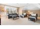 Comfortable living room features a black leather sofa and a large window for natural light at 255 Williamston Ridge Dr, Youngsville, NC 27596