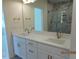 Double vanity bathroom featuring a large mirror, stylish fixtures, and ample counter space at 2617 Packhouse Rd, Zebulon, NC 27597