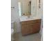 Bathroom vanity featuring light wood cabinets, quartz countertop, brushed nickel faucet and hardware at 2617 Packhouse Rd, Zebulon, NC 27597