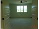 Bright bedroom featuring a large window and ceiling fan providing ample natural light and ventilation at 2617 Packhouse Rd, Zebulon, NC 27597