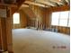 Spacious bonus room with exposed wood framework with natural light from the windows at 2617 Packhouse Rd, Zebulon, NC 27597