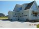 Attached two-car garage on an exterior view with a long driveway and manicured landscaping at 2617 Packhouse Rd, Zebulon, NC 27597