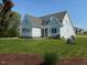 Well-designed home boasts a manicured lawn and inviting curb appeal, perfect for families at 2617 Packhouse Rd, Zebulon, NC 27597