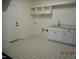 Bright laundry room with ample cabinet space and a stylish, patterned tile floor for added convenience at 2617 Packhouse Rd, Zebulon, NC 27597