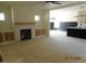Open-concept living area with a cozy fireplace, built-in cabinets, and a seamless kitchen view at 2617 Packhouse Rd, Zebulon, NC 27597