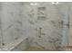 Luxurious marble tiled shower with built-in bench and modern fixtures at 2617 Packhouse Rd, Zebulon, NC 27597