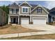 Charming two-story home with a two-car garage and stone accents on the facade at 280 N Maple Walk # 233, Garner, NC 27529