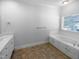Bathroom with soaking tub, dual vanity, and neutral decor at 30 Alvis Ct, Fuquay Varina, NC 27526