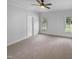Spacious carpeted bedroom with two windows and a ceiling fan for added comfort at 30 Alvis Ct, Fuquay Varina, NC 27526