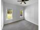 Empty bedroom shows carpet, neutral paint, two windows, and ceiling fan at 30 Alvis Ct, Fuquay Varina, NC 27526