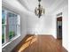 Sunlit dining room with hardwood floors, wainscoting, and decorative chandelier at 30 Alvis Ct, Fuquay Varina, NC 27526