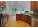 Open kitchen showcasing stainless steel appliances, wood cabinets, and a breakfast bar at 30 Alvis Ct, Fuquay Varina, NC 27526