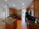 Spacious kitchen featuring dark wood cabinets, granite countertops, and modern appliances at 30 Alvis Ct, Fuquay Varina, NC 27526