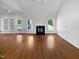 Bright living room featuring vaulted ceilings, fireplace, hardwood floors and a large window for natural light at 30 Alvis Ct, Fuquay Varina, NC 27526
