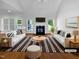 Bright living room featuring vaulted ceilings, fireplace, hardwood floors and a large window for natural light at 30 Alvis Ct, Fuquay Varina, NC 27526