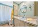 Cozy bathroom with a vintage sink, neutral cabinets, and a shower with curtain enclosure at 3011 Kenan Rd, Durham, NC 27704