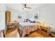 Sunny bedroom with hardwood floors, ceiling fan, writing desk, and natural light from the windows at 3011 Kenan Rd, Durham, NC 27704