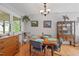Dining room features hardwood floors, a round wooden table with views of greenery at 3011 Kenan Rd, Durham, NC 27704