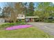 Two-story home with blooming flowers, manicured lawn, and covered carport at 3011 Kenan Rd, Durham, NC 27704