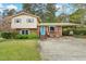 Charming brick home with a well-manicured lawn and cozy carport offering shade for vehicles at 3011 Kenan Rd, Durham, NC 27704