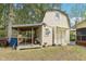 Exterior view of an outbuilding with covered deck area, providing additional workspace or storage at 3011 Kenan Rd, Durham, NC 27704