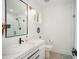 Modern bathroom with marble countertop, sleek black fixtures, and tiled shower with glass door at 3016 Sylvania Dr, Raleigh, NC 27607