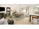 Bright dining area with seating for eight, showcasing a modern chandelier and large windows for ample natural light at 3016 Sylvania Dr, Raleigh, NC 27607