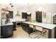 Well-appointed kitchen boasts dark cabinetry, stainless steel appliances, ample counter space, and a breakfast bar with seating at 3016 Sylvania Dr, Raleigh, NC 27607