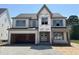 Under-construction two-story home featuring a two-car garage and a classic facade at 3516 Amelia Grace Dr # 31, Fuquay Varina, NC 27526