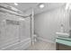 This remodeled bathroom offers a soaking tub with a white tile surround and a glass shower door at 3518 Travis Ct, Chapel Hill, NC 27516